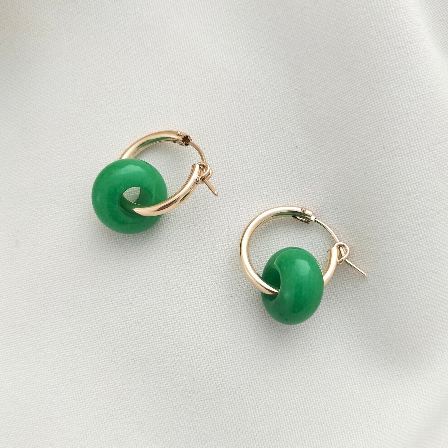 Gold hoop earrings with green jade beads